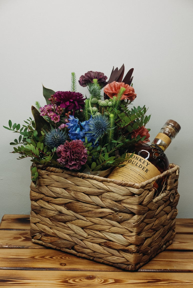 Purple Flowers in Brown Woven Basket